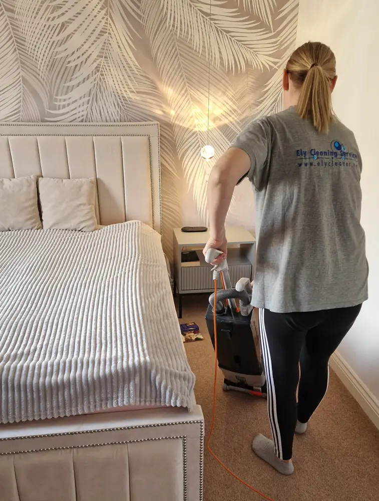 vacuuming carpet for professional cleaning in Ely