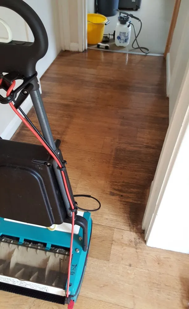 Hard floor in Ely before cleaning, showing Truvox machine and dirt buildup.