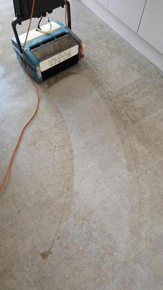 Before and after professional deep cleaning of a kitchen hard floor, showing restored shine and cleanliness