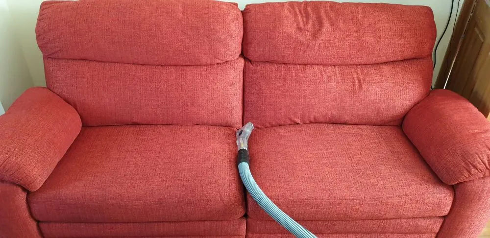 Red sofa in Ely after professional upholstery cleaning, looking fresh, stain-free, and revitalized