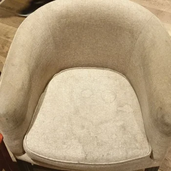 Professional upholstery cleaning in Newmarket - heavily stained armchair before deep cleaning treatment.